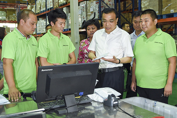 Premier Li Keqiang says strong logistics services are needed to support the e-commerce industry, during a visit to the Henan Bonded Logistics Center in Zhengzhou, Henan province, on Sept 24,2015. (Photo/Xinhua)