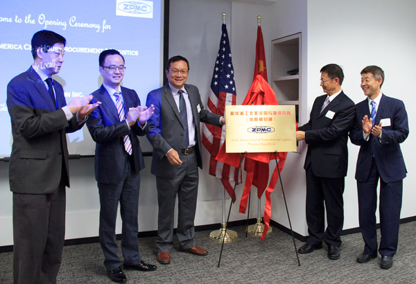 From left: Alan Ye and Zheng Min, both managers at ZMPC; Yi Luping, president of CCCC USA; Chinese Consul Cao Derong and Li Shaolin, president of CGCC, unveil a plaque marking the opening of ZPMC North America Center of Procurement and Logistics on Monday. (Photo/China Daily USA)
