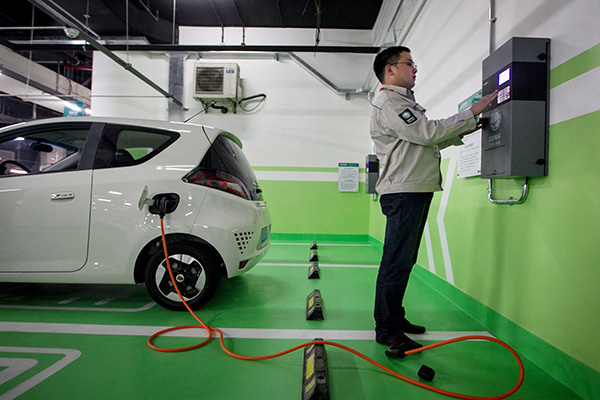 A State Grid engineer examines charging facilities in Shanghai. The State Council recently released a guideline to accelerate the construction of electric car charging facilities. (Photo/China Daily)
