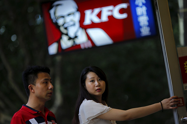 Customers walk into a KFC restaurant in Shanghai. Yum Brands Inc, the owner of KFC and Pizza Hut, has 6,867 restaurants in its China division, which contributed 57 percent of the company's overall revenue. (Photo/China Daily)