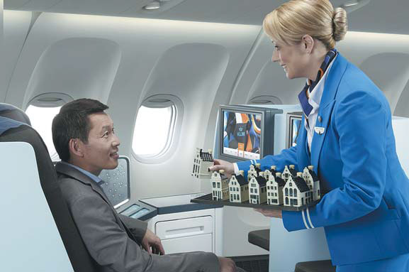 A KLM Royal Dutch Airlines stewardess serves a passenger. Provided to China Daily