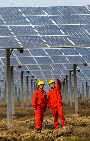 Engineers inspect the electric equipment of a photovoltaic power generation project under trial operation in Changxing county, Zhejiang province.(Photo/Xinhua)