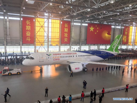 The mobile phone photo taken on Nov. 2, 2015 shows the C919, China's first homemade large passenger aircraft, at a plant of Commercial Aircraft Corporation of China, Ltd. (COMAC), in Shanghai, east China. The C919 was rolled out of the final assembly line in Shanghai on Monday. It will make its maiden flight next year and then begin test flights for about three years before putting into commercial use. (Photo: Xinhua/Ding Ting)