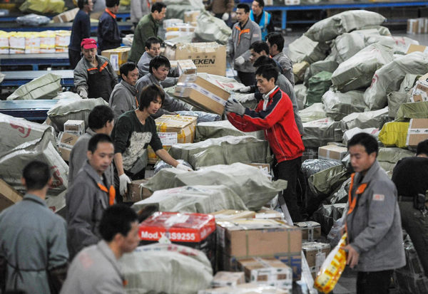 Working staff distribute packs in an express company in Hangzhou, East China's Zhejiang province, Nov 12, 2012. The annual Single's Day which falls on Nov 11 has become a shopping festival under a continuous sales promotion of e-commerce groups. (Photo/Xinhua)