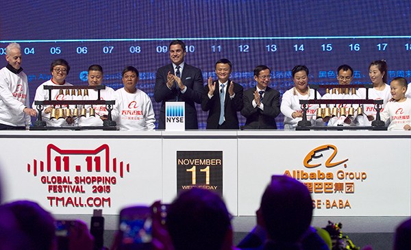Jack Ma, executive chairman of Alibaba, along with Alibaba CEO Zhang Yong (right) and Tom Farley, president of the New York Stock Exchange, celebrate as charity representatives ring Chinese bells to open the exchange on Nov 11, 2015. (Photo/China Daily)