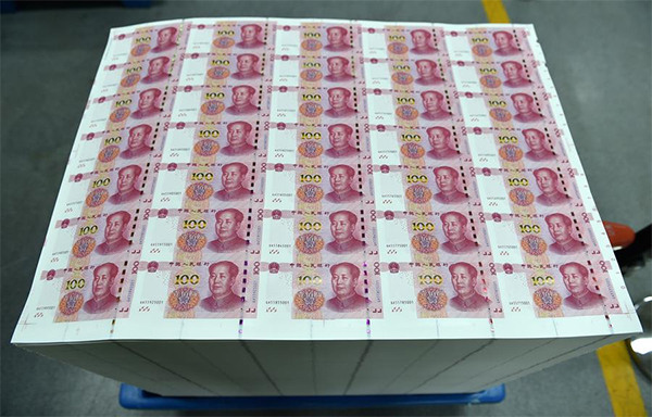 New 100-yuan notes wheeled out in the factory of China Banknote Printing and Minting Corporation, Oct 29. (Photo/Xinhua)