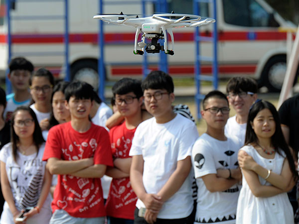A group of people pose for a picture by using a drone camera in Nanjing, Jiangsu province. (Photo provided to China Daily)