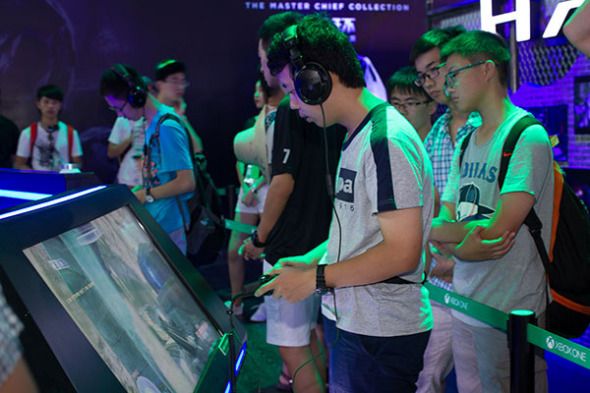 Visitors check out games at the China Digital Entertainment Expo & Conference that opened in Shanghai on Thursday. TV-based games are no longer popular as players turn to smartphones and tablets for gaming needs. (Photo/China Daily)