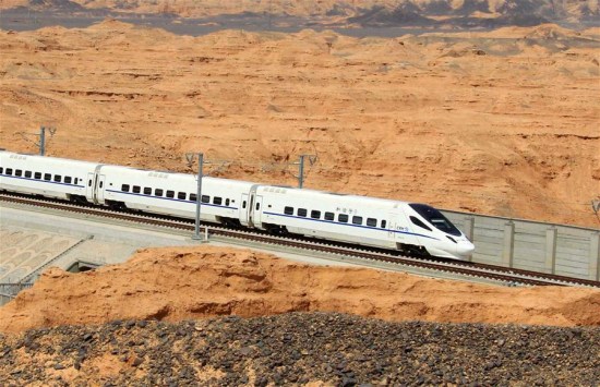 Photo taken April 23, 2015 shows a high-speed train moving past a Yadan landform in northwest China's Xinjiang Uygur Autonomous Region. (Photo: Xinhua/Cai Zengle)