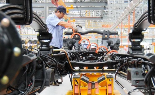 A worker is occupied on a production line at a workshop under the AVIC in Xingtai, north China's Hebei Province, Sept. 11, 2015. China's economy grew by 6.9 percent in 2015. (Xinhua file photo/Zhu Xudong)