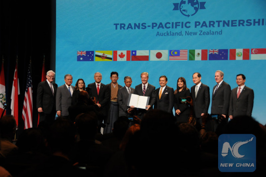 Trade representatives of the 12 Trans-Pacific Partnership (TPP) member nations pose for a group photo at the official signing ceremony in Auckland, New Zealand, on Feb. 4, 2016. (Photo: Xinhua/Tian Ye)