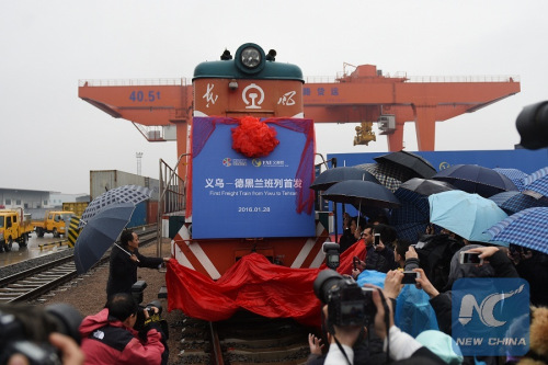 Honored guests unveil the first regular container train linking China to the Middle East in Yiwu, east China's Zhejiang Province, Jan. 28, 2016. The train will exit China through Alataw Pass in northwest China's Xinjiang and pass through Kazakhstan and Turkmenistan before reaching its destination Tehran, capital of Iran, completing a 14-day and 10,399-kilometer journey. (Xinhua Photo)