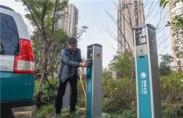 A driver charges his car at a facility in Suzhou, Jiangsu province.YANG LEI/XINHUA