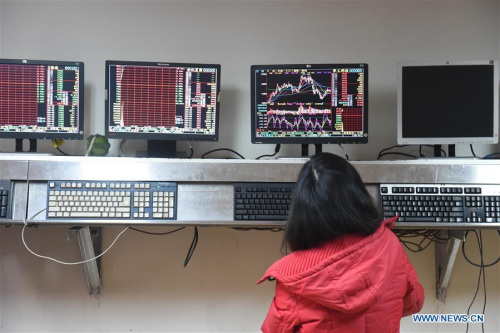An investor looks through stock information at a trading hall in a securities firm in Changchun, capital of northeast China's Jilin Province, Feb. 25, 2016. Chinese stock market closed down more than six-percent on Thursday, with the benchmark Shanghai Composite Index plunged 6.41 percent, to 2,741.25 points. (Photo: Xinhua/Zhang Nan)