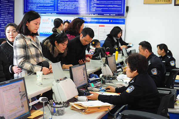 Police in charge of exit and entry management receive passport applications in Fuyang, Anhui province, in February. Applicants are looking for work overseas. (Wang Biao / for China Daily)