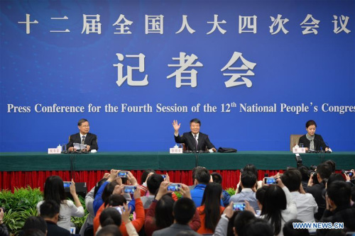 Xu Shaoshi (C), minister in charge of the National Development and Reform Commission, gives a press conference for the fourth session of China's 12th National People's Congress (NPC) on the country's economic and social development and the draft outline of the 13th Five-Year Plan, in Beijing, capital of China, March 6, 2016. (Photo: Xinhua/Li Xin) 