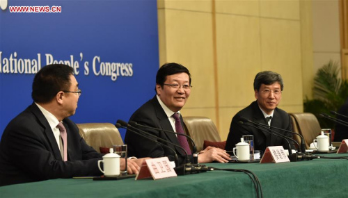 Chinese Minister of Finance Lou Jiwei (C)and Xu Hongcai (R), assistant minister of finance, give a press conference on the sidelines of the fourth session of the 12th National People's Congress at the press center in Beijing, capital of China, March 7, 2016. (Xinhua/Zhao Yingquan)