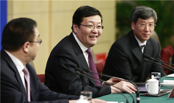 Minister of Finance Lou Jiwei answers reporters' questions during a news conference in Beijing on Monday. FENG YONGBIN / CHINA DAILY