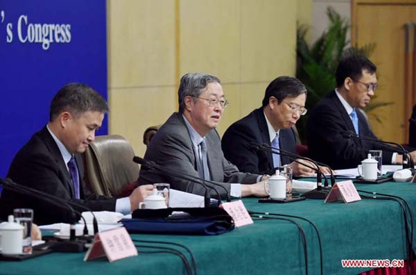 Governor of the People's Bank of China (PBC) Zhou Xiaochuan (2nd L) and PBC deputy governors Yi Gang (2nd R), Pan Gongsheng (1st L) and Fan Yifei (1stR) give a press conference on the financial reform and development on the sidelines of the fourth session of the 12th National People's Congress in Beijing, capital of China, March 12, 2016. (Xinhua/Xue Yubin)