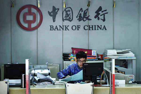A worker at a Bank of China branch in Hangzhou, Zhejiang province. Chinese banks have the ability to withstand risks with a provision coverage ratio of 180 percent. (Photo/China Daily)