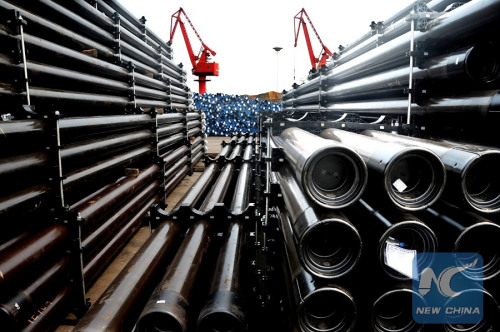 Photo taken on Aug. 1, 2015 shows steel tubes at a dock in Lianyungang Port, east China's Jiangsu Province. (Photo: Xinhua/Wang Chun)