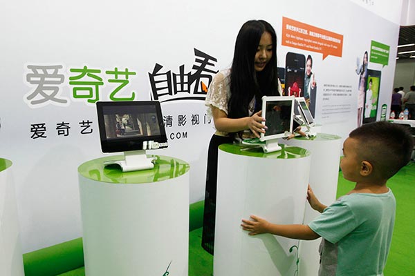 A boy checks out iQiyi video content at an international copyright fair in Beijing. DA WEI / FOR CHINA DAILY