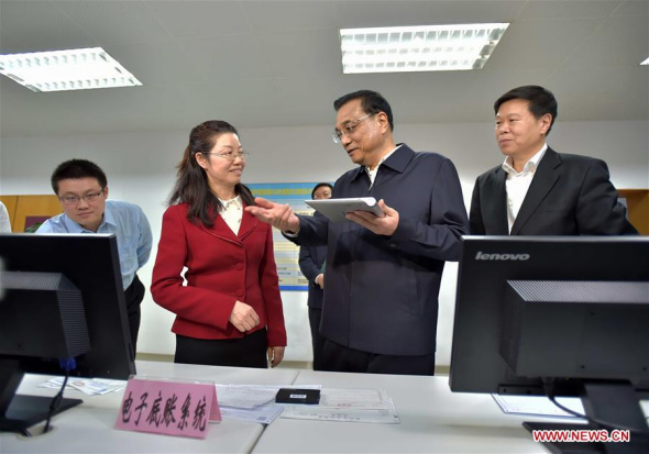Chinese Premier Li Keqiang (2nd R) visits the State Administration of Taxation in Beijing, capital of China, April 1, 2016. Li Keqiang inspected the State Administration of Taxation and the Ministry of Finance on April 1, urging solid efforts from the financial and taxation authorities to deliver the value-added tax (VAT) reform as part of efforts to invigorate the real economy. (Photo: Xinhua/Li Tao)