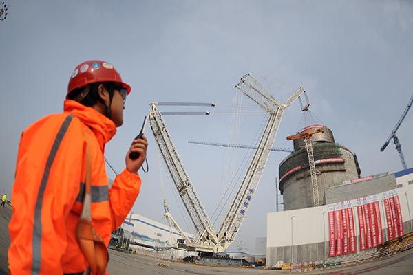 A worker monitors a construction site at Haiyang nuclear power plant in Shandong province. TANG KE / FOR CHINA DAILY