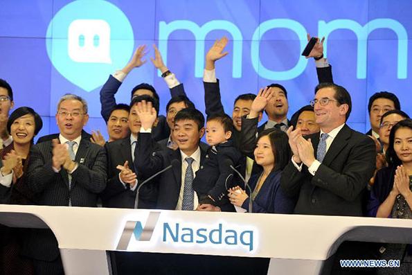 Tang Yan (center, front), founder and chief executive officer of China's mobile social networking platform Momo Inc attends the ceremony of ringing the opening bell at the NASDAQ in New York, the United States, Dec 11, 2014. (Photo/Xinhua)