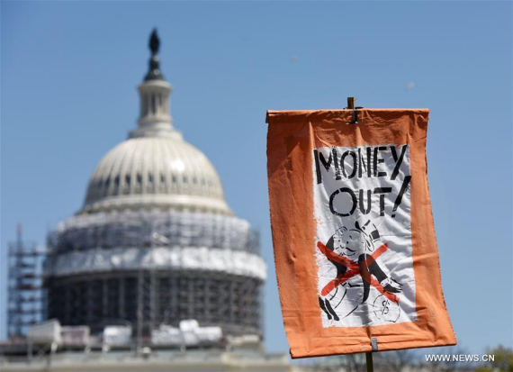 Banners are seen in front of the Capitol during a rally against Money Politics in Washington D.C., the United States, on April 17, 2016. (Photo: Xinhua/Yin Bogu)