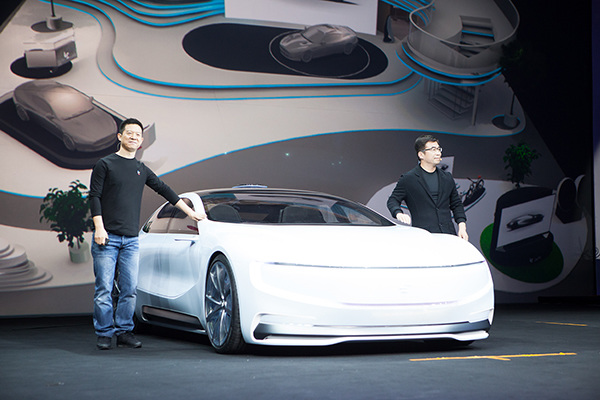 Jia Yueting(left), CEO of LeEco, and Ding Lei, LeSEE co-founder and global vice president, pose a picture with the company's first full-electronic automobile--LeSEE on April 20, 2016 during a product launch event held in Beijing. (Photo provided to chinadaily.com.cn)