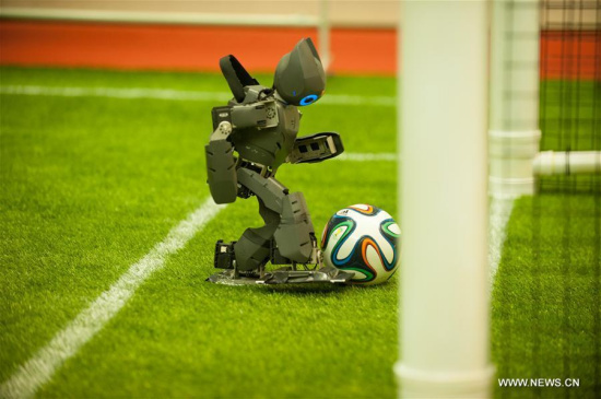 A robot from Sichuan University practises shooting before a competition during the 2016 RoboCup China Open in Hefei, capital of east China's Anhui Province, April 26, 2016. Nearly 2,000 participants from 300 teams across the country took part in the competitions. (Photo: Xinhua/Meng Dingbo)