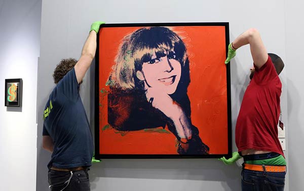 Staff members set up a creation of Andy Warhol at the Art Basel in Hong Kong, March 24, 2016. A total of 239 galleries from 35 countries and regions attended the 3-day Art Basel in Hong Kong this year. (Photo/Xinhua)