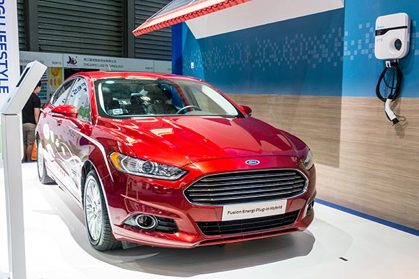 Ford Fusion Energi Plug-in hybrid car is displayed, with a charging box on the wall, at an exhibition in Shanghai last year. HAO YAN / CHINA DAILY