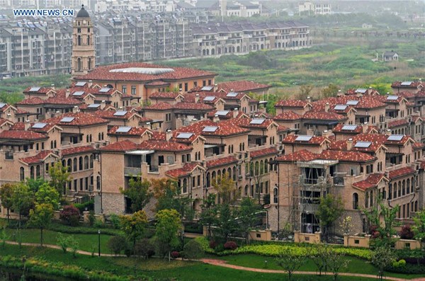Photo taken on April 10, 2016 shows residential buildings in Huzhou City, east China's Zhejiang Province. According to data released by Zhejiang Provincial Bureau of Statistics, sales acreage and revenues of commodity houses in Zhejiang were 14.80 million square meters and 166.1 billion RMB yuan (about 25.5 billion U.S. dollars), 64 percent and 83 percent year on year respectively in the first quarter of 2016. (Xinhua/Tan Jin)