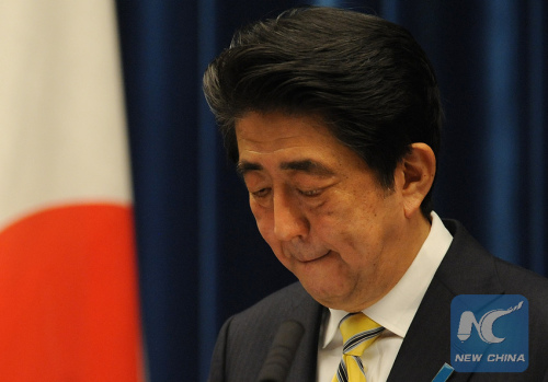 Japanese Prime Minister Shinzo Abe bites his lips during a press conference at his official residence in Tokyo, Japan, Nov. 21, 2014. (Photo: Xinhua/Stringer)