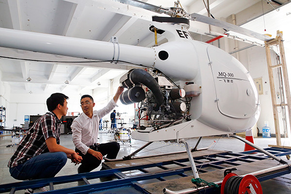 Technicians check a pilotless helicopter at a startup company in the Binhai New Area of Tianjin. (Photo provided to China Daily)