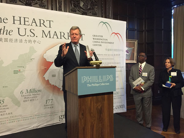 Max Baucus, U.S. Ambassador to China, makes a keynote speech as Jim Coleman, President and CEO of Prince George's County Economic Development Corporation; and Libby Garvey, chair of the Arlington County Board, look on at a GWCIC reception for the Chinese business delegation in Washington on Sunday. (Photo by Cai Chunying /China Daily)