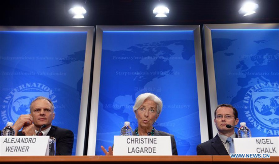 The International Monetary Fund(IMF) Managing Director Christine Lagarde (C) speaks at a press conference in Washington D.C., the United States, on June 22, 2016. (Xinhua/Yin Bogu)