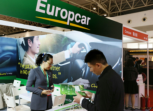 A man looks at brochures about auto touring at a recent outbound tourism fair in Beijing. The fair attracted more than 400 companies engaged in various travel services from 70 countries. (Photo provided to China Daily)