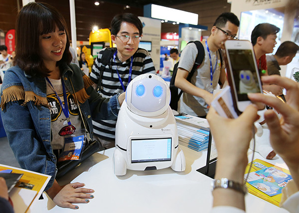 An intelligent robot on display attracts visitors at an industry expo in Beijing. (Wang Zhuangfei/China Daily)