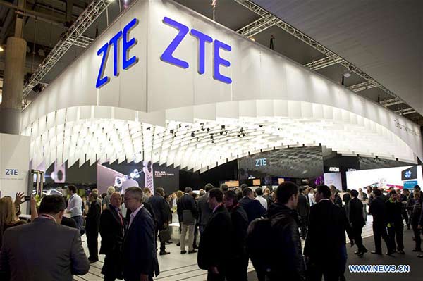 Visitors walk in front of the ZTE stand at the Mobile World Congress 2016 in Barcelona, Spain, Feb 22, 2016. (Photo/Xinhua)
