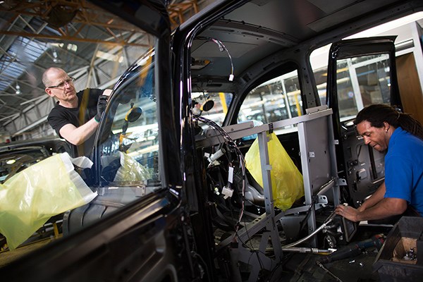 Employees work on black TX4 Euro 5 London taxi cabs as they move along the production line at the London Taxi Company's assembly plant, a unit of Zhejiang Geely Holding Co, in Coventry, UK, in March, 2014. (Photo provided to China Daily)