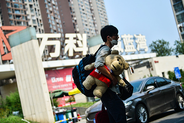 A man walks out of a China Vanke development in Tianjin. (Photo/China Daily)