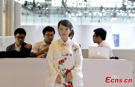 Humanoid robot Jia Jia interacts with visitors at the Annual Meeting of the New Champions, part of the World Economic Forum's various themed gatherings and also known as 'Summer Davos', in Tianjin, June 27, 2016. (Photo: China News Service/Zhang Daozheng)
