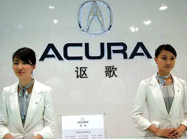Two Acura hostesses stand at the Japanese brand's booth at the Shanghai auto show in 2007. Due to its obscurity, Acura is often confused with local Chinese brand Changan. (Photo/China Daily)