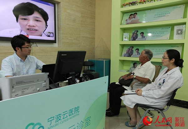 A patient, accompanied by a community doctor, talks with an invited doctor at a online consultation in a community clinic in Ningbo. (Photo/zj.people.cn)