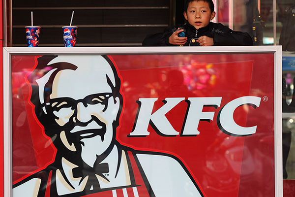 A boy plays at a KFC restaurant in Nantong, Jiangsu province. Yum Brands Inc, owner of KFC and Pizza Hut chains, gets more than half of its revenue from China. (Photo/China Daily)