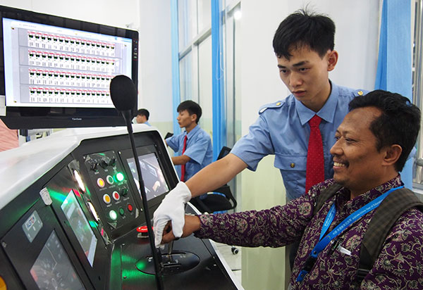 A representative from State Polytechnic Samarinda in Indonesia tries a high-speed railway control system in Guiyang, Guizhou province, on Tuesday.ZENG JUN/CHINA DAILY