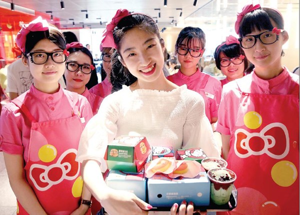 A girl holds a tray of Hello Kitty-themed food products at a McDonald's restaurant in downtown Beijing. JIANG DONG/CHINA DAILY